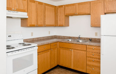 Kitchen with maple cabinets and white appliances